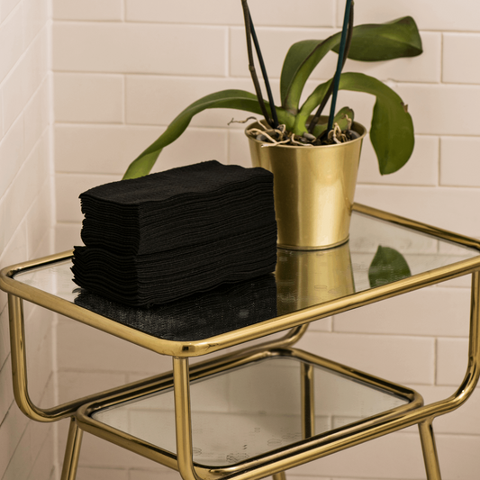  Image of Scrummi original waffle towels from a hand towel bundle, showcasing their textured waffle design. The towels are neatly folded, with the soft, black fabric visible, emphasising their absorbent and durable nature. The bundle is arranged in a stac